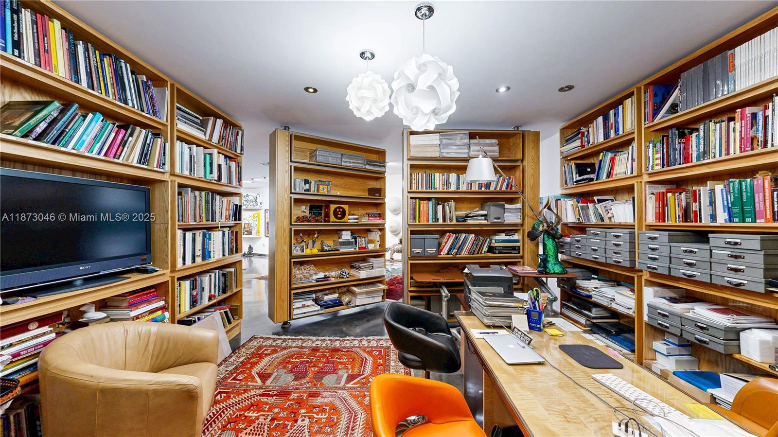 2101 Tigertail Avenue Miami, FL 33133 - Photo 29 of 92 a living room with lots of furniture and a book shelf