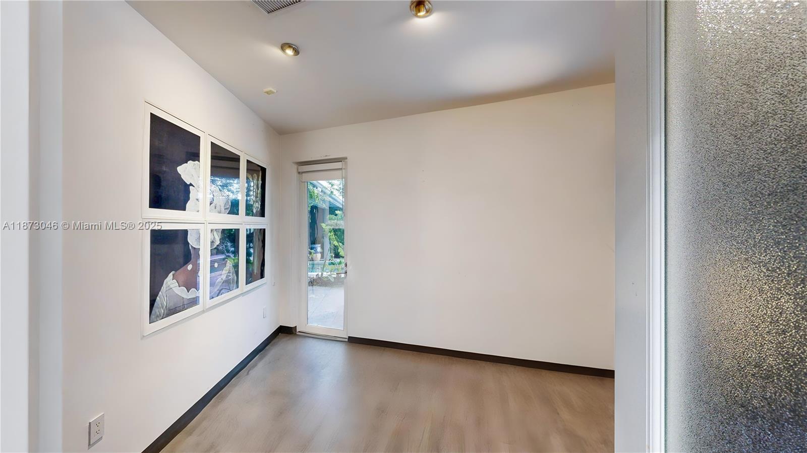 2101 Tigertail Avenue Miami, FL 33133 - Photo 31 of 92 a view of an empty room with a window and workspace