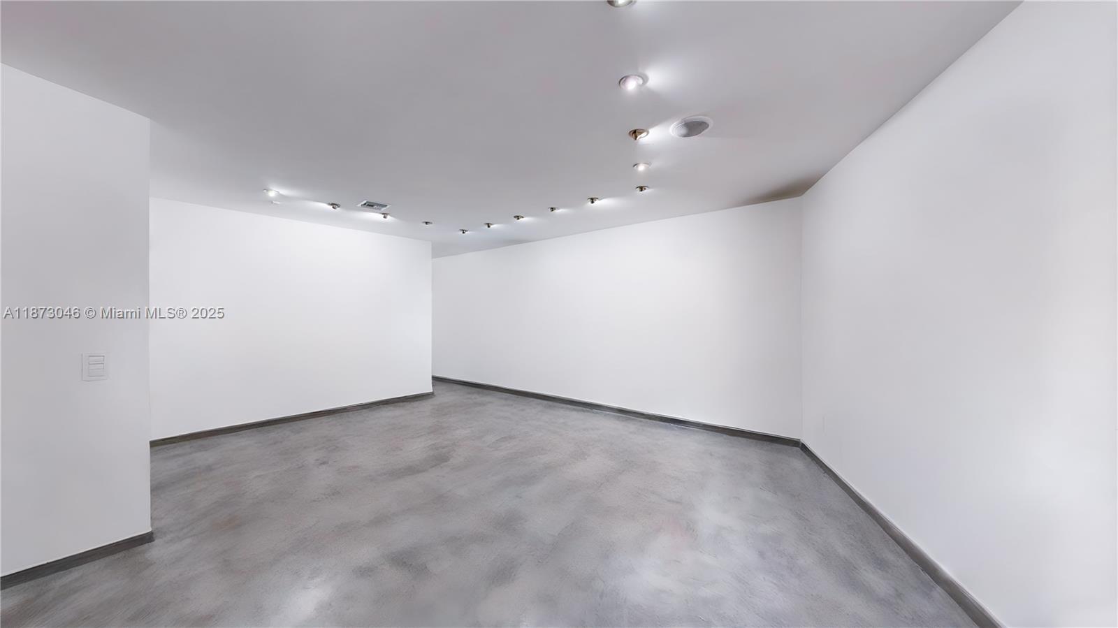 2101 Tigertail Avenue Miami, FL 33133 - Photo 35 of 92 an empty room with a empty space and windows