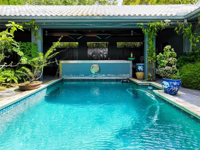 a front view of a house with a large garden