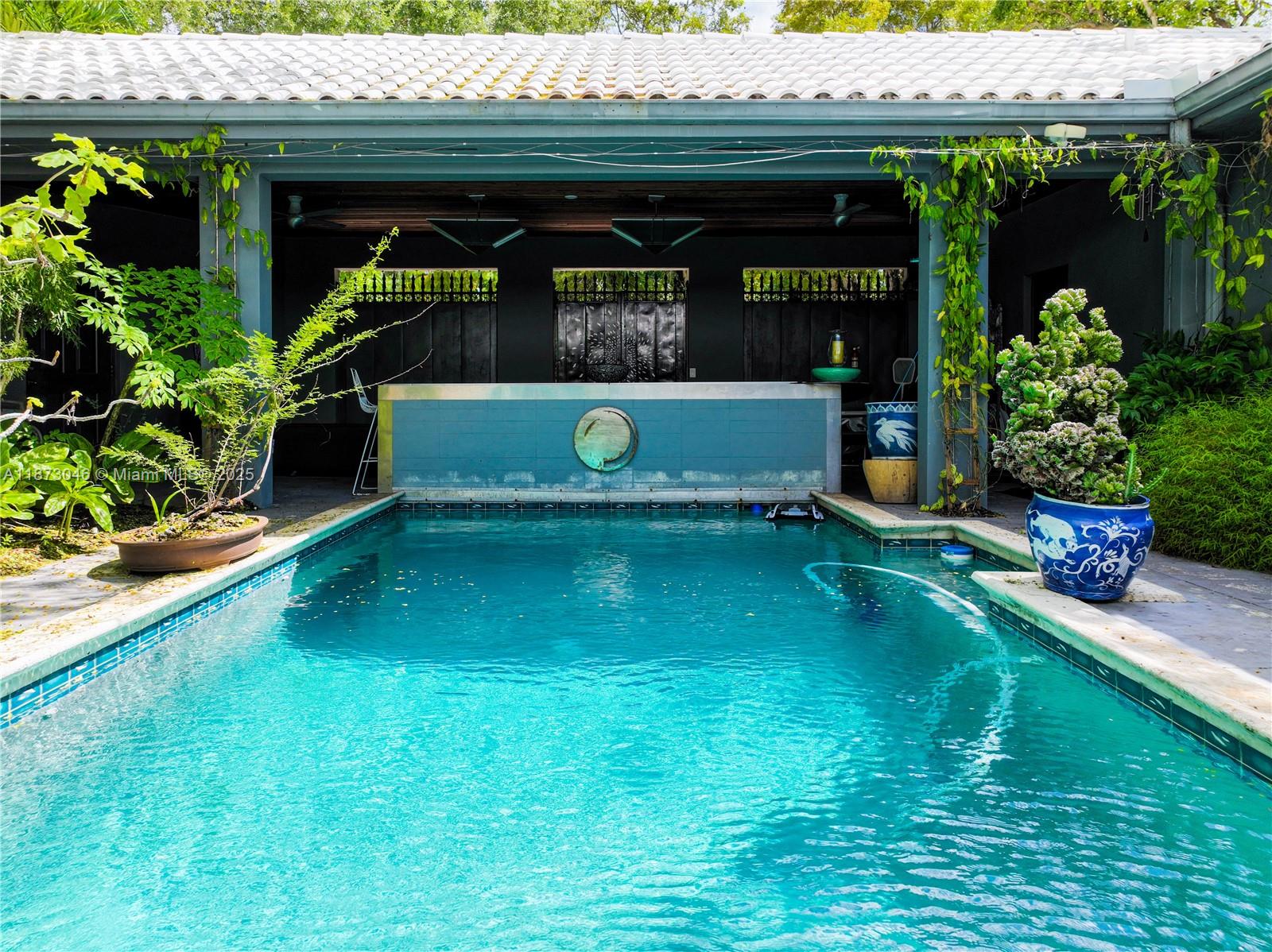 2101 Tigertail Avenue Miami, FL 33133 - Photo 4 of 92 a view of a swimming pool with a patio