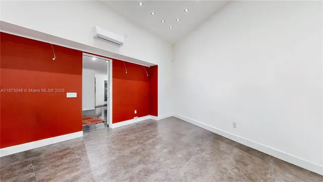 an aerial view of a house with a yard and trees all around