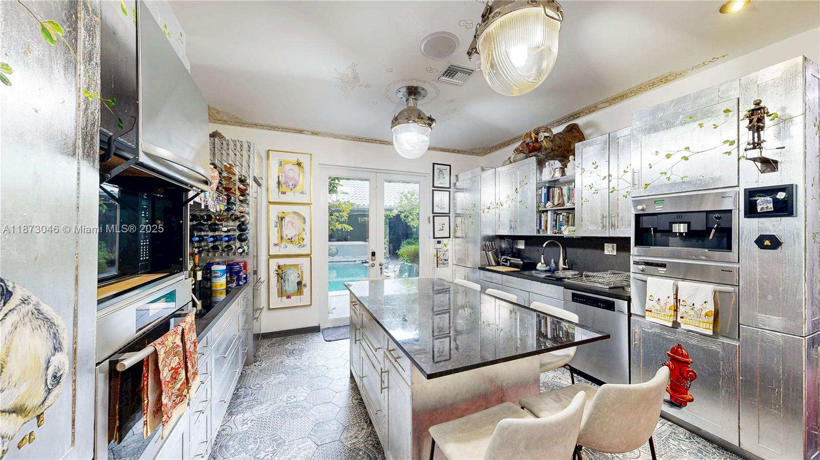 2101 Tigertail Avenue Miami, FL 33133 - Photo 47 of 92 a kitchen with stainless steel appliances granite countertop a stove and a refrigerator