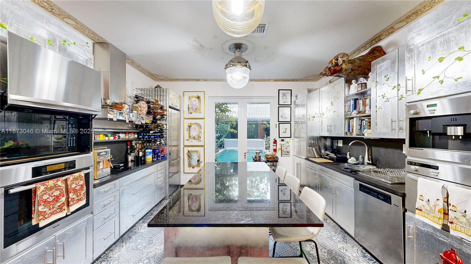 2101 Tigertail Avenue Miami, FL 33133 - Photo 48 of 92 a kitchen with stainless steel appliances granite countertop a stove and cabinets