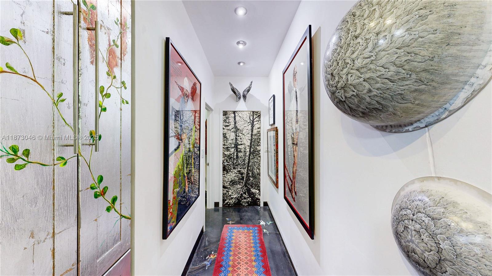 2101 Tigertail Avenue Miami, FL 33133 - Photo 50 of 92 a view of a hallway with paintings on the wall