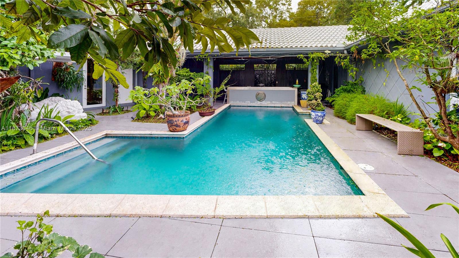 2101 Tigertail Avenue Miami, FL 33133 - Photo 6 of 92 a view of house with garden and a bench