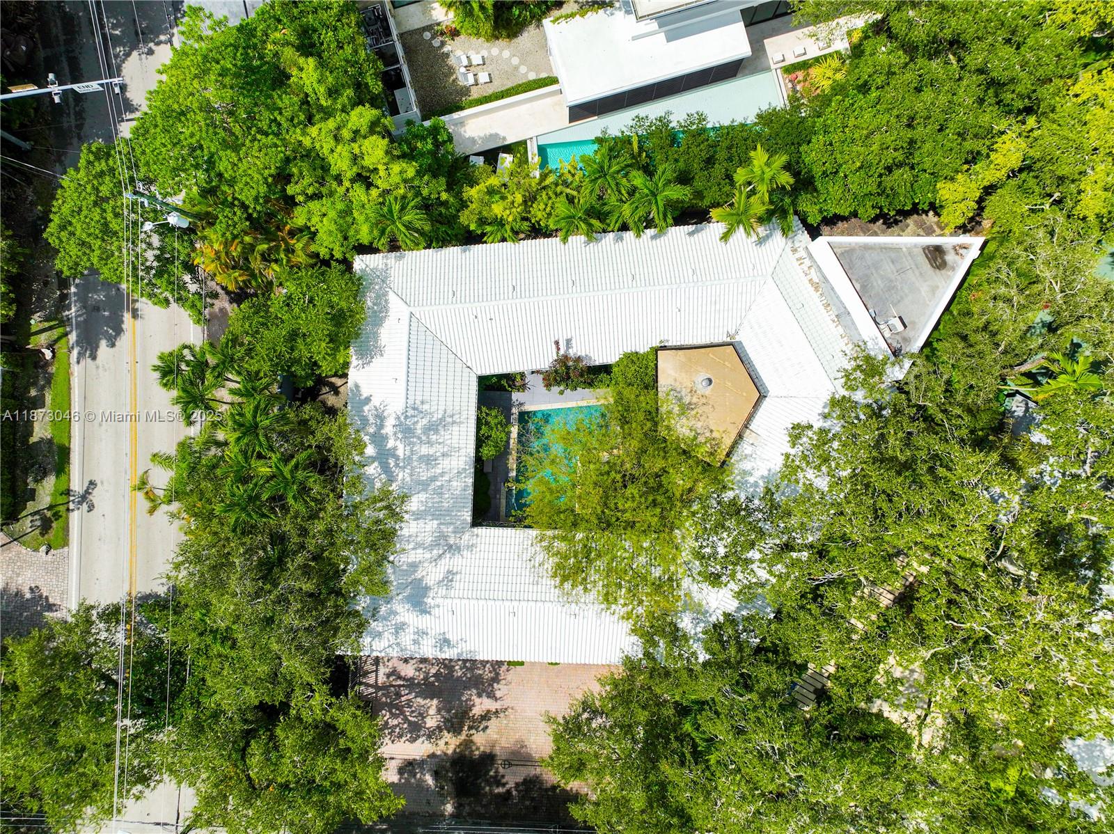 2101 Tigertail Avenue Miami, FL 33133 - Photo 70 of 92 an aerial view of a house with a yard and trees all around
