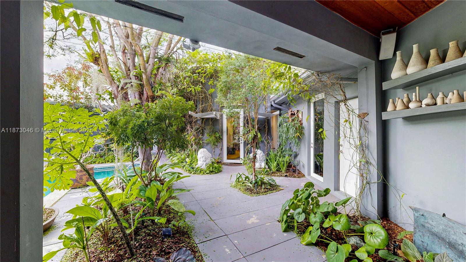 2101 Tigertail Avenue Miami, FL 33133 - Photo 7 of 92 a front view of a house with a large garden