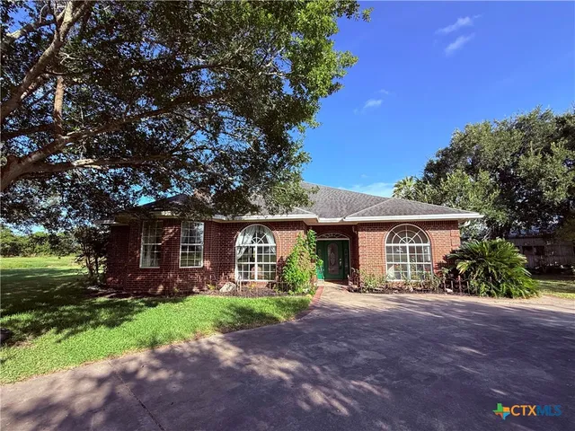 a front view of house with yard and green space