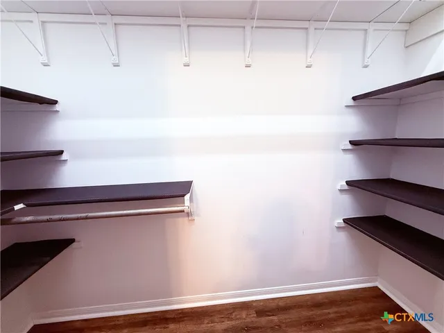 a view of storage and utility room with racks on the wall