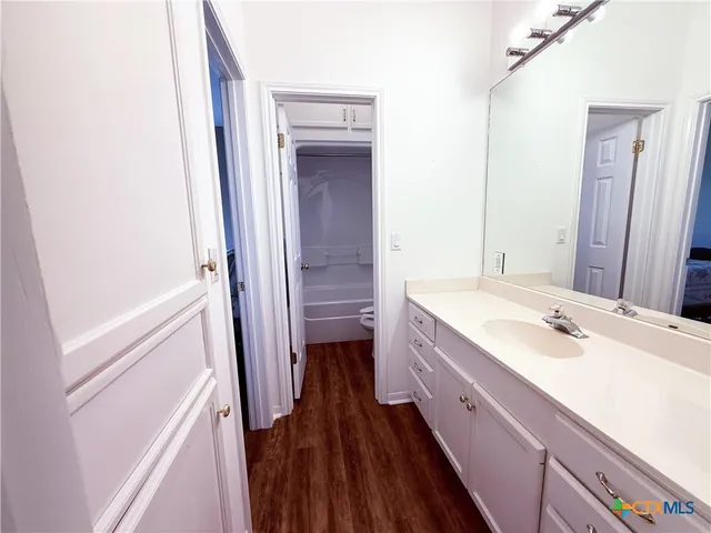 a bathroom with a sink a toilet and vanity