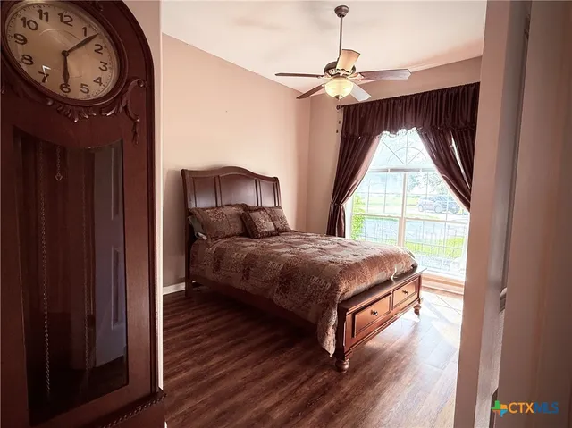 a bedroom with a bed a mirror and a window