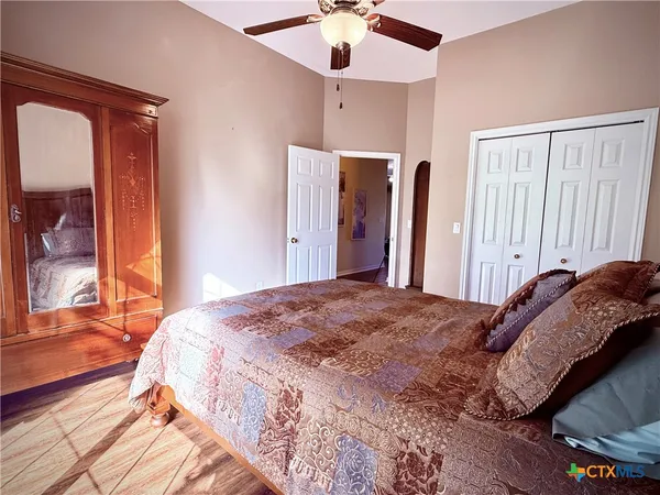 a bedroom with a bed and a chandelier