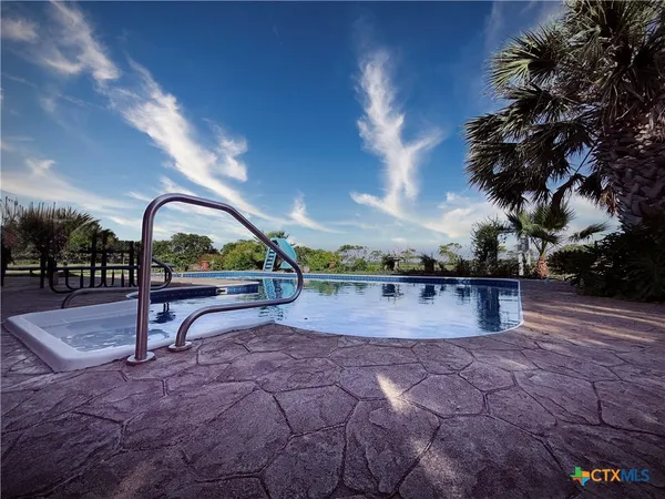 a view of swimming pool and sitting area