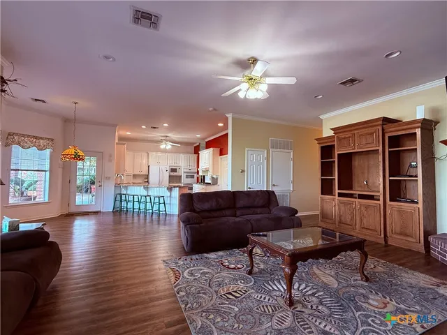a living room with furniture ceiling fan and a rug