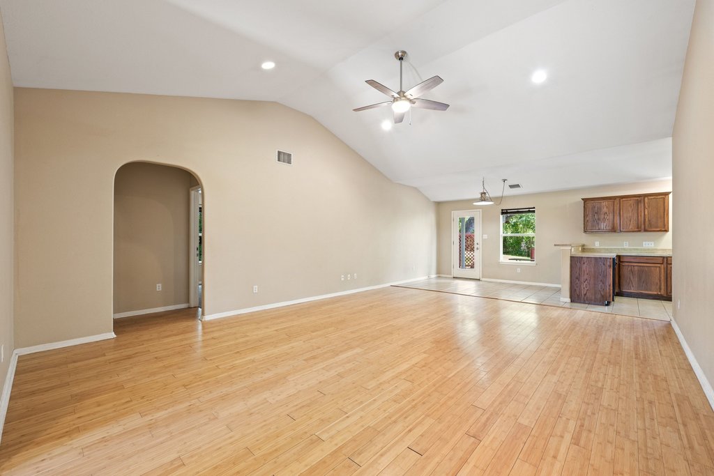 5208 Sioux Lane Austin, TX 78734 - Photo 15 of 35 A well-lit living area features high vaulted ceilings and polished hardwood flooring.