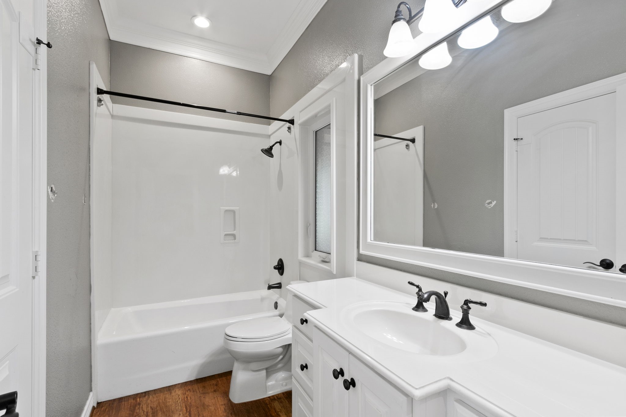 17018 Grant Road Cypress, TX 77429 - Photo 24 of 50 a bathroom with a sink a toilet a mirror and shower