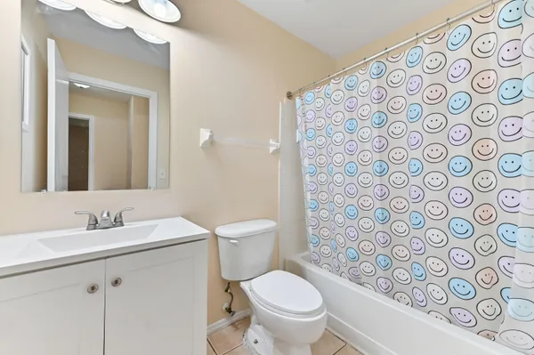 a bathroom with a toilet sink shower and mirror