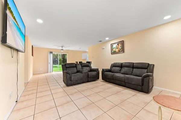 a living room with couches and a flat screen tv