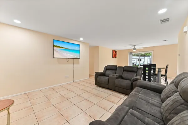 a living room with furniture and a painting on the wall