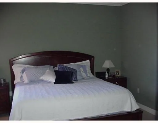 a bedroom with a bed and a night stand