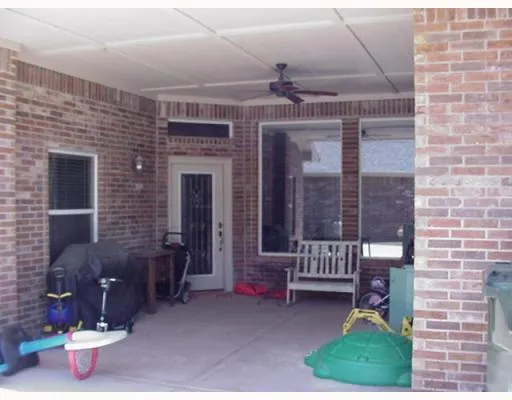 a backyard of a house with outdoor seating