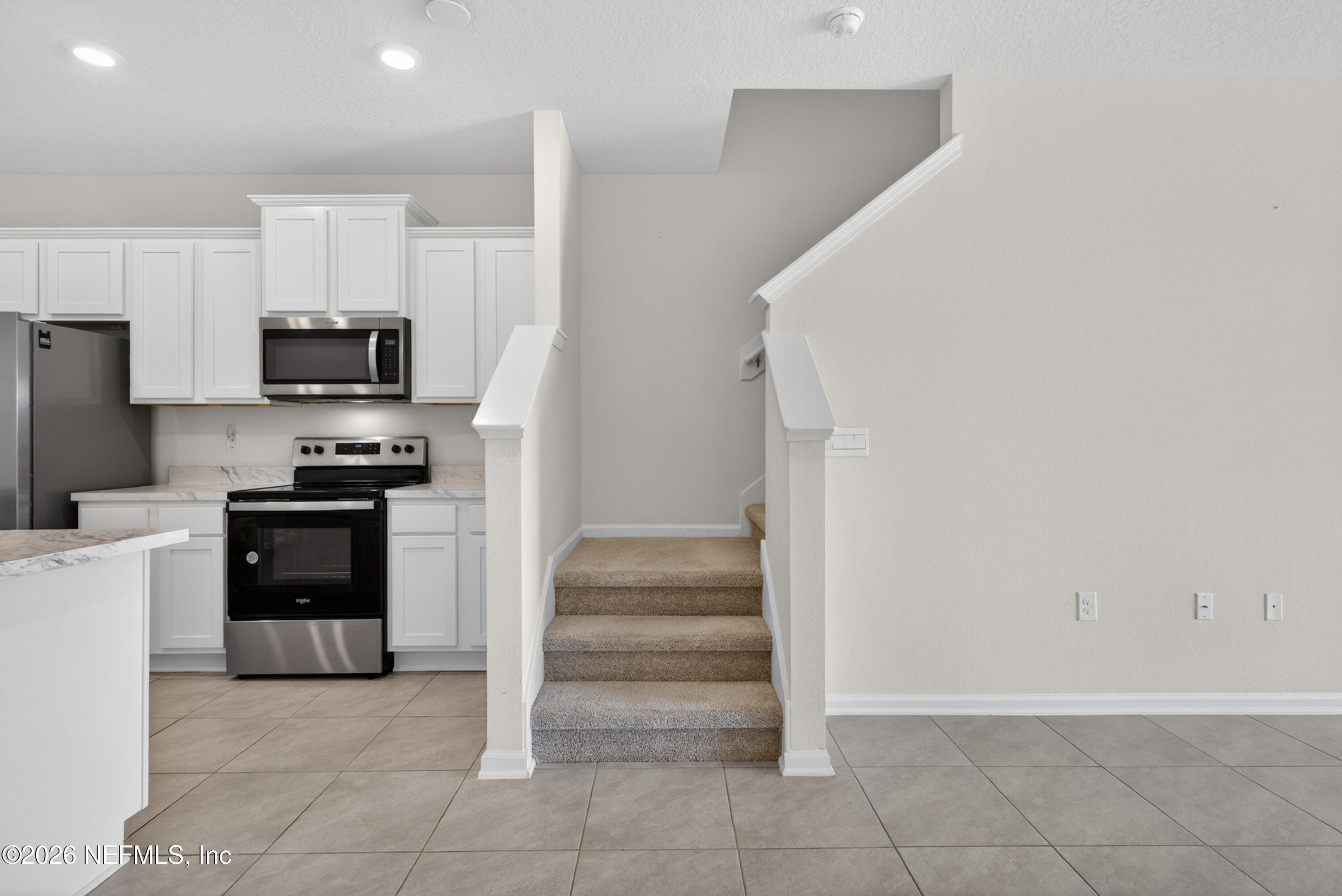 8210 Larose Road Jacksonville, FL 32211 - Photo 16 of 38 a kitchen with a refrigerator and a stove top oven