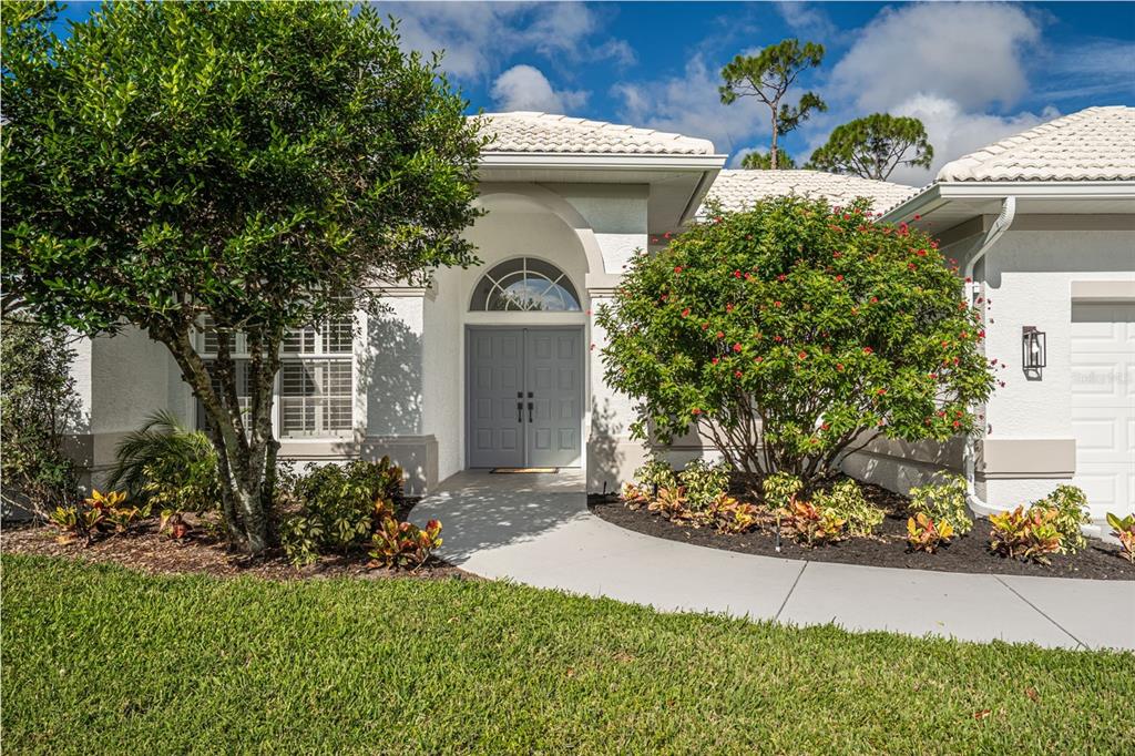 629 Sawgrass Bridge Road Venice, FL 34292 - Photo 3 of 36 a view of a house with a small yard and plants