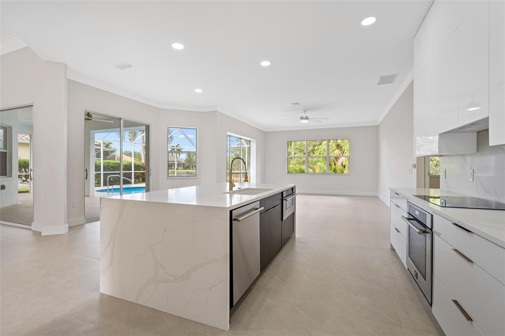629 Sawgrass Bridge Road Venice, FL 34292 - Photo 10 of 36 a large kitchen with stainless steel appliances granite countertop a lot of counter top and a stove