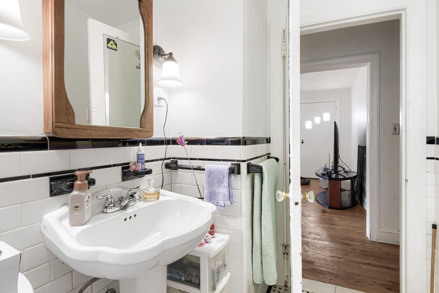 217 Doris Avenue Baltimore, MD 21225 - Photo 11 of 16 a bathroom with a sink and a mirror