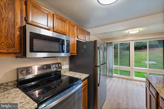 a kitchen with stainless steel appliances a stove a microwave and a refrigerator