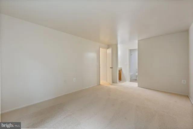 a view of an empty room and a window