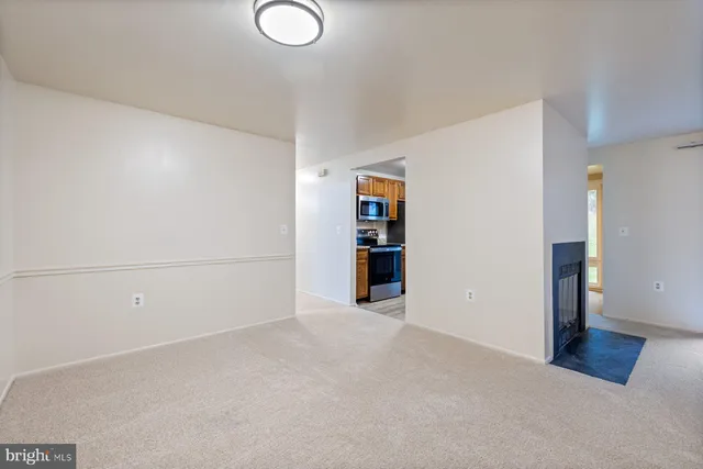 a view of an empty room with closet