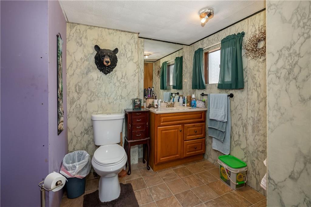 184 Oak Ridge Drive Butler, PA 16002 - Photo 11 of 16 a bathroom with a toilet sink and mirror