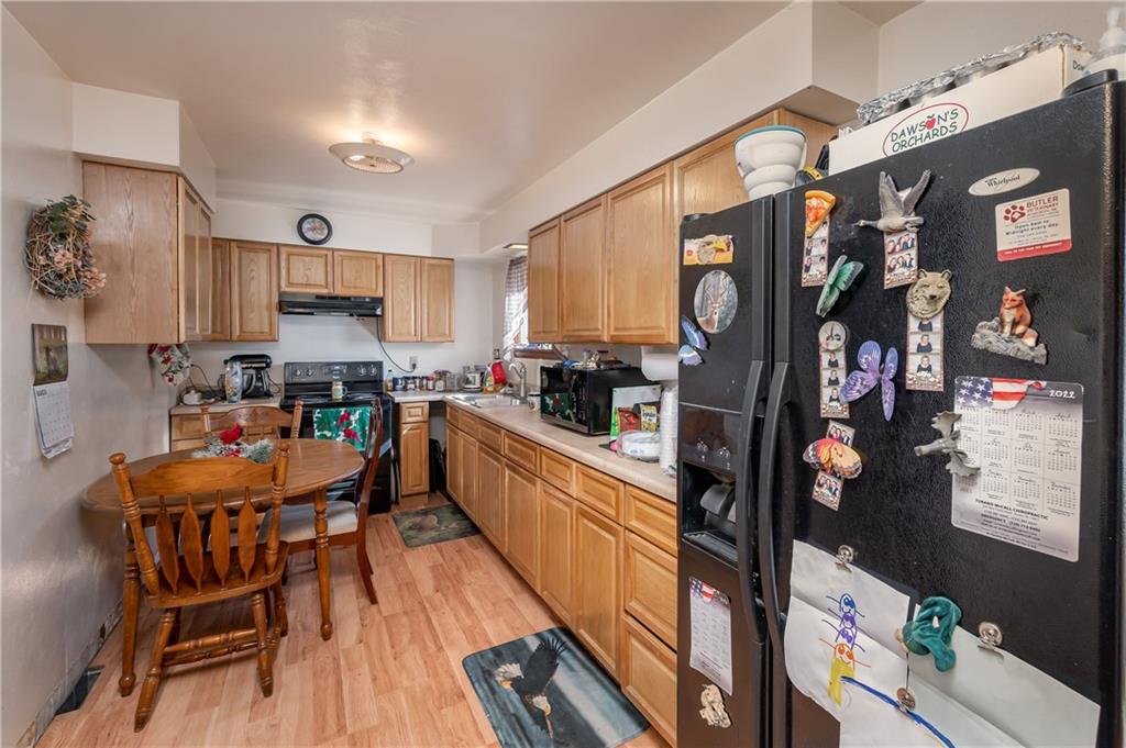 184 Oak Ridge Drive Butler, PA 16002 - Photo 5 of 16 a kitchen with stainless steel appliances granite countertop a refrigerator and a stove top oven