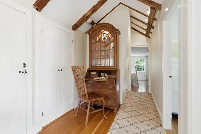 a view of a hallway with wooden floor windows and entryway