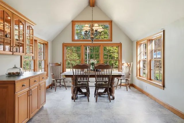 a view of a dining room with furniture a chandelier and wooden floor