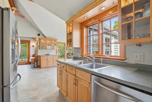 a kitchen with a sink and large windows