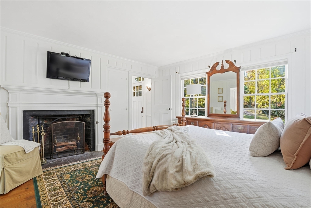 178 Main Street Plympton, MA 02367 - Photo 5 of 37 a spacious bedroom with a bed and a fireplace