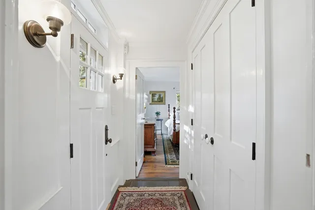 a view of a hallway with wooden floor and staircase