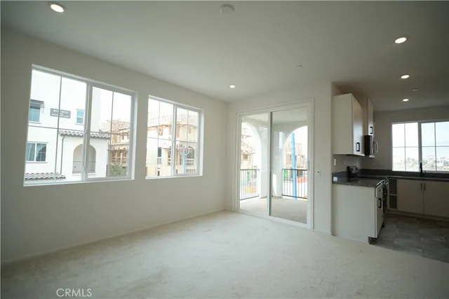 a open kitchen with kitchen island a sink stove and a refrigerator