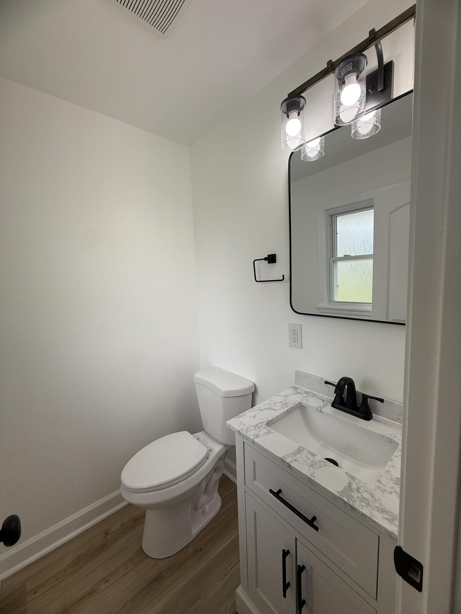 408 Cherry Hill Road Dyer, IN 46311 - Photo 13 of 31 a bathroom with a granite countertop toilet sink and mirror