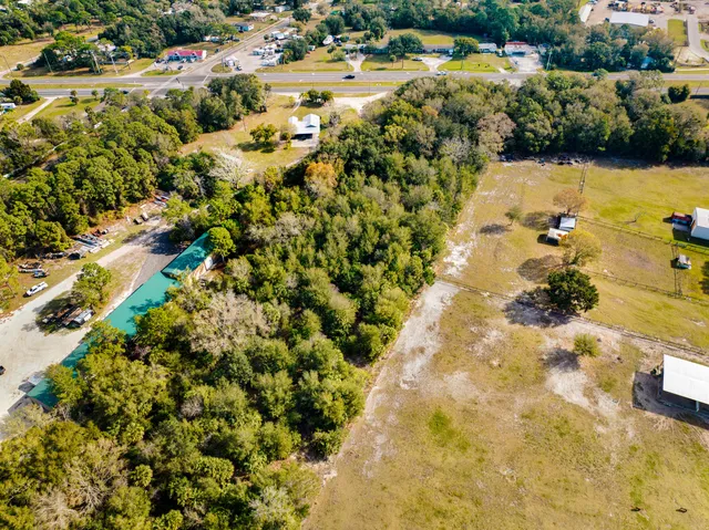 an aerial view of residential houses with outdoor space