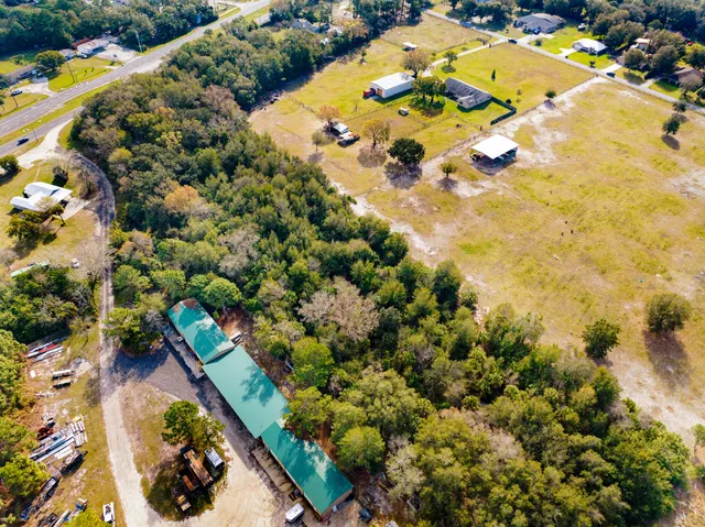 an aerial view of residential houses with swimming pool and outdoor space