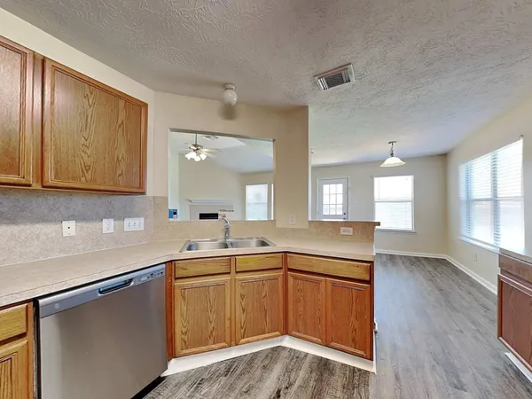 a kitchen with a sink stove and cabinets