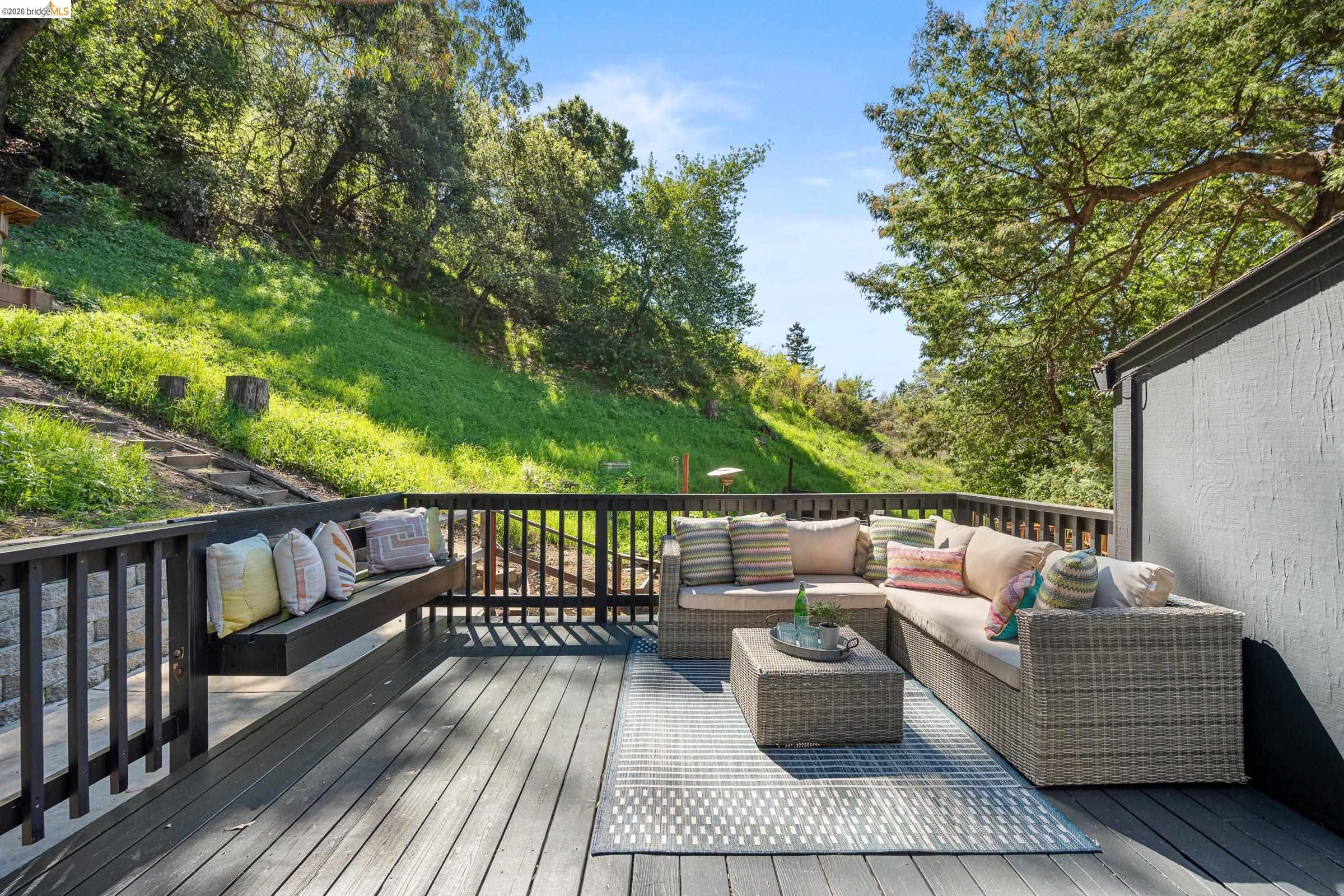 6600 Heather Ridge Way Oakland, CA 94611 - Photo 49 of 66 Expansive outdoor deck featuring dark wood-finish flooring, a built-in bench, and dark wood railings