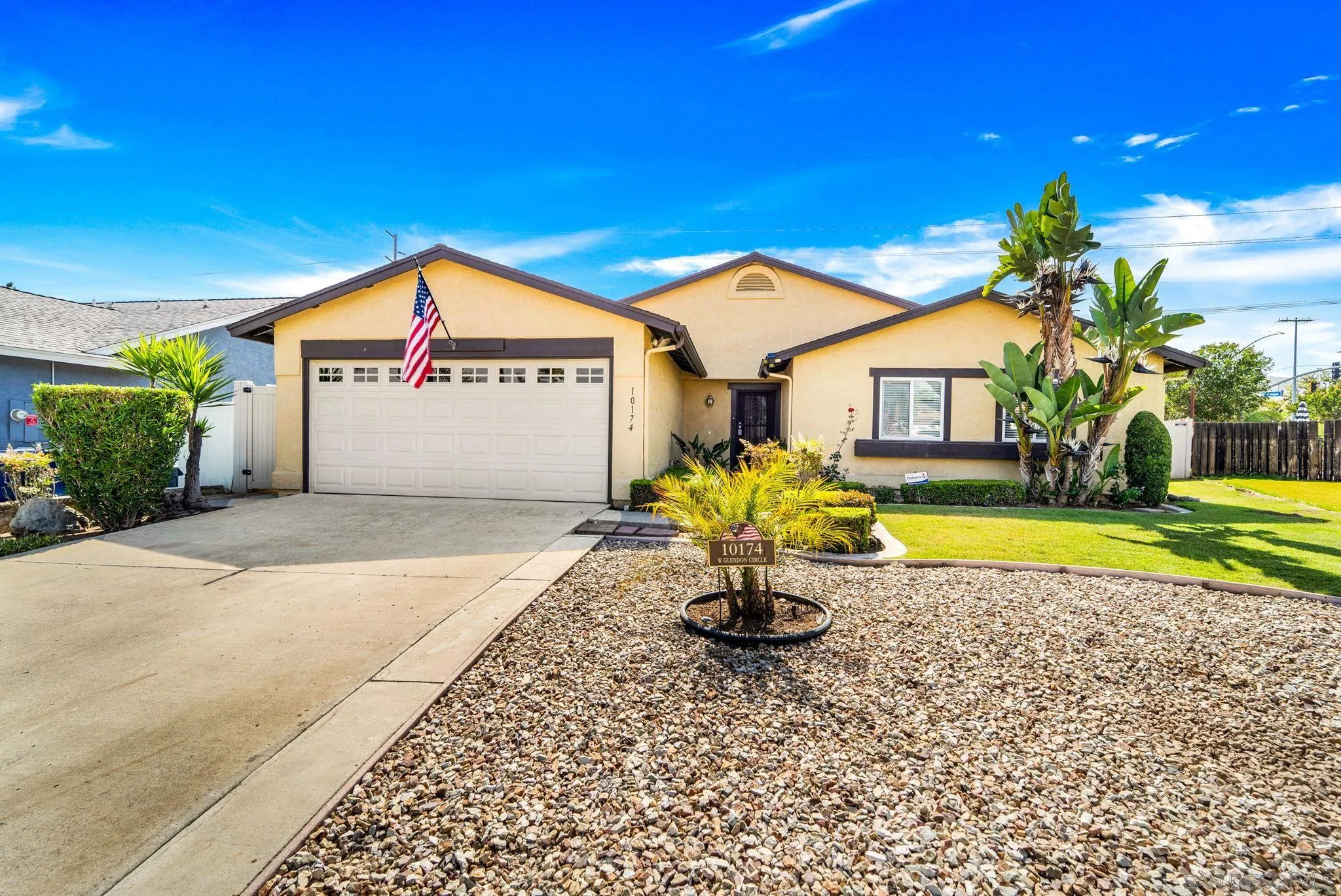 a view of a house with a swimming pool and sitting area