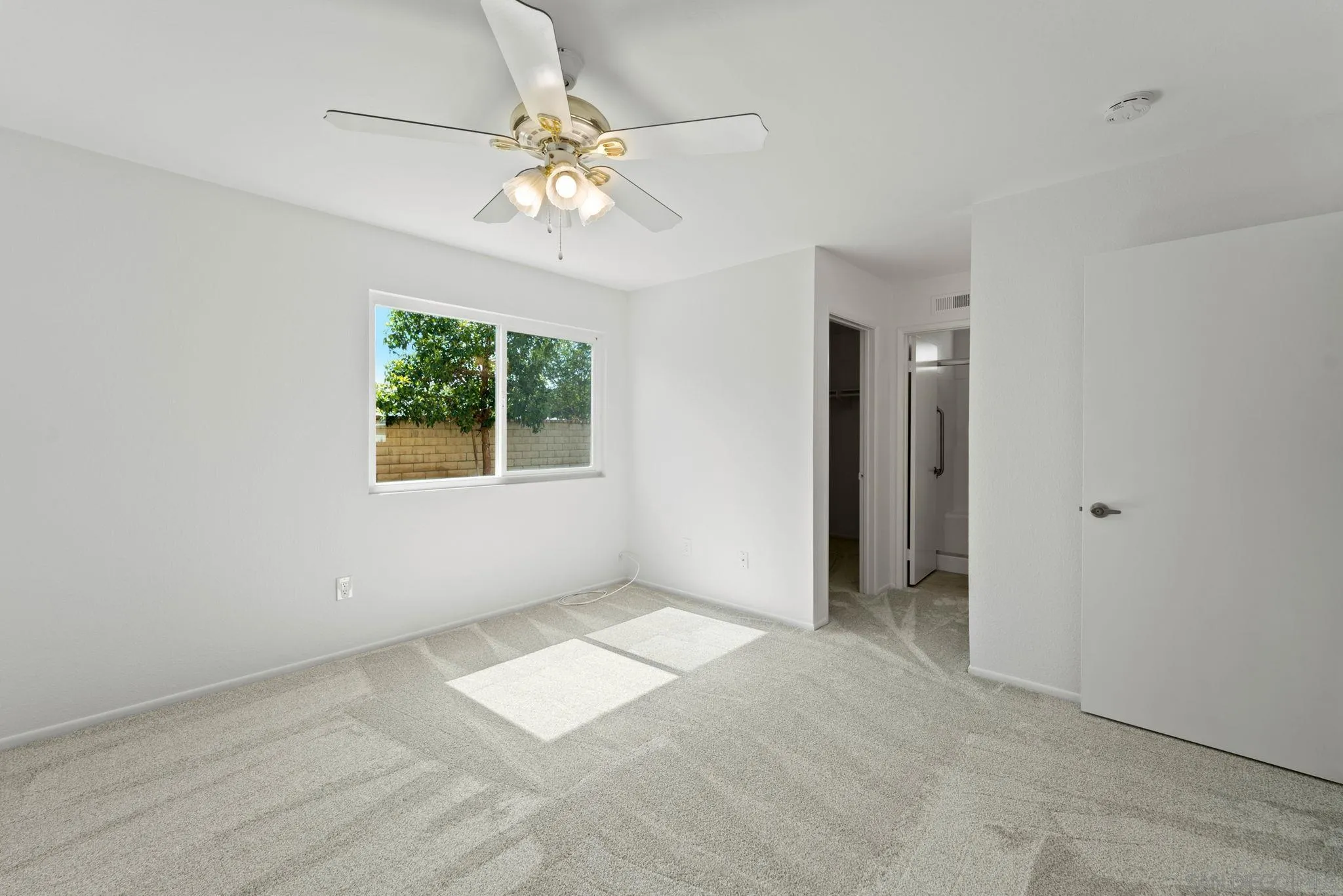 10174 West Glendon Circle Santee, CA 92071 - Photo 14 of 41 an empty room with chandelier fan and windows