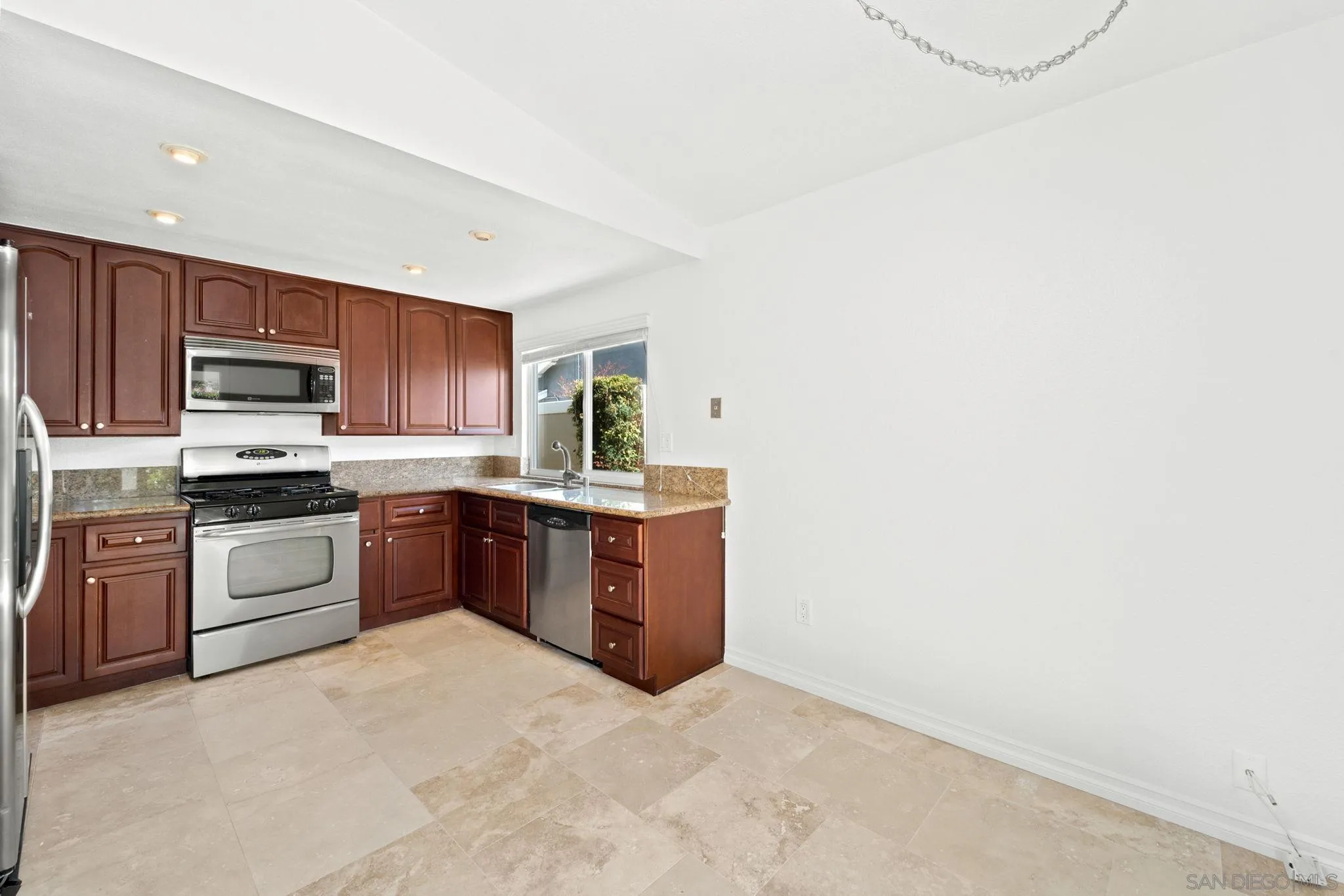 10174 West Glendon Circle Santee, CA 92071 - Photo 30 of 41 a large kitchen with stainless steel appliances granite countertop a stove a sink a refrigerator a microwave oven with cabinets