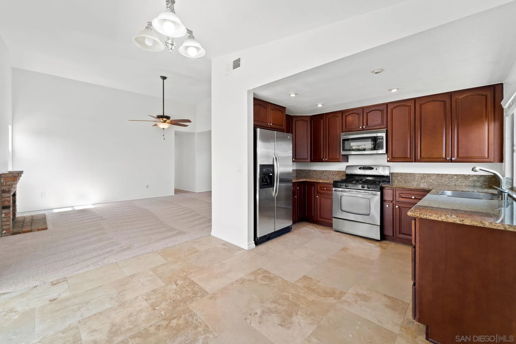 10174 West Glendon Circle Santee, CA 92071 - Photo 31 of 41 a kitchen with stainless steel appliances granite countertop a refrigerator sink and cabinets